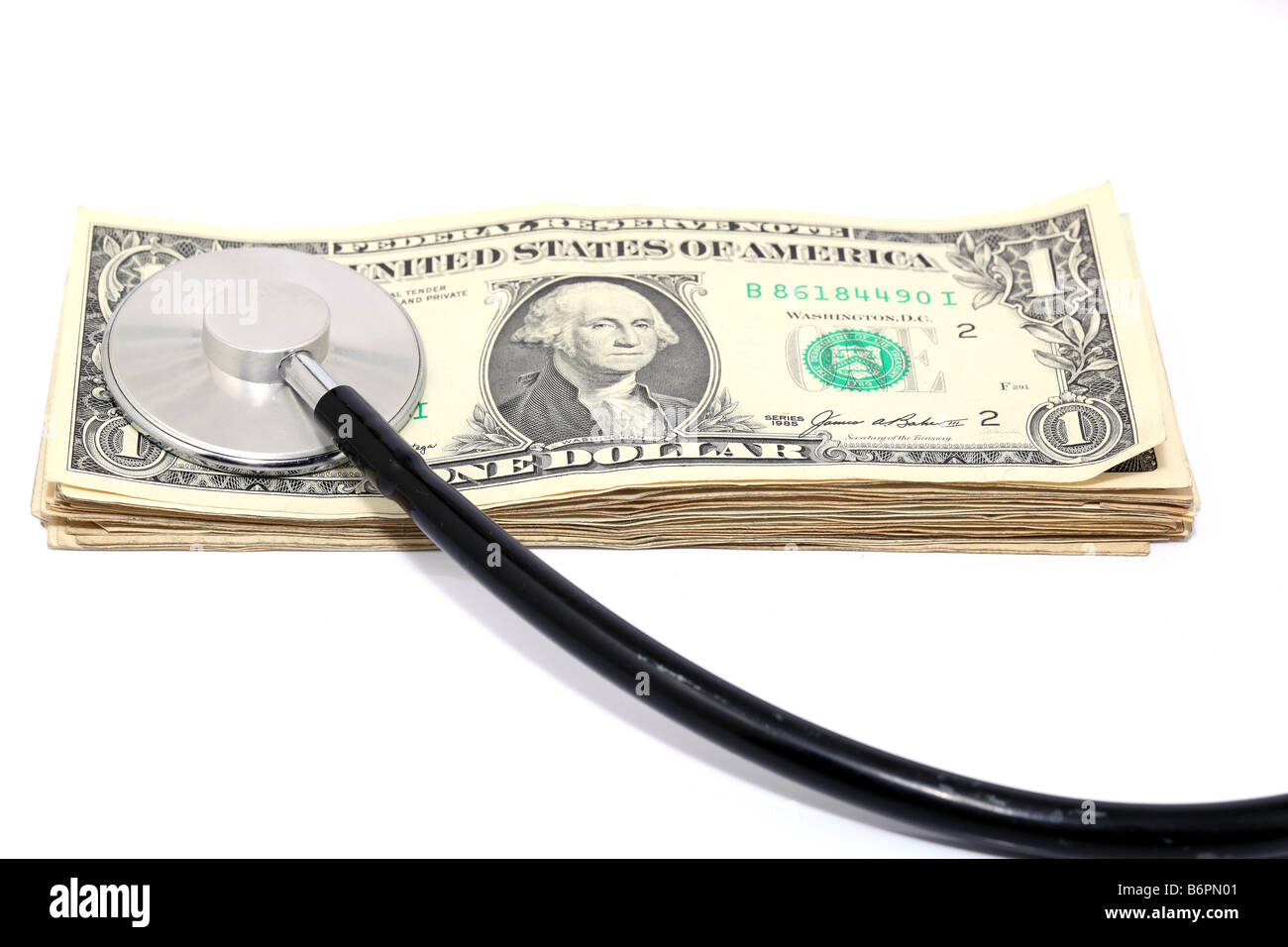 expensive health treatment stethoscope and dollars isolated Stock Photo