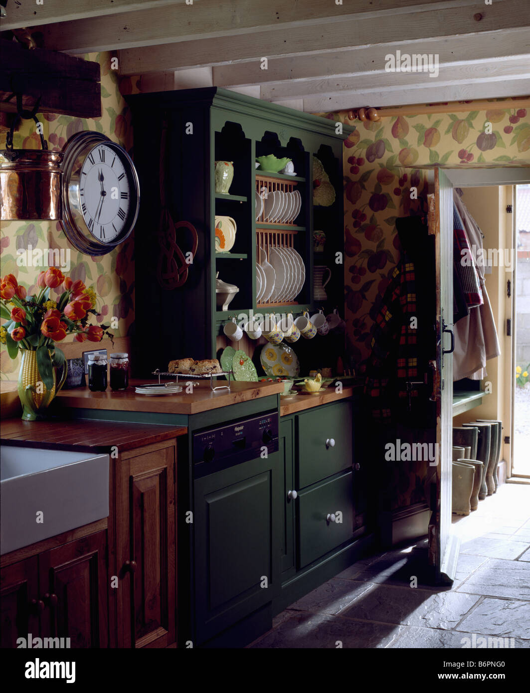 Clock On Wall Beside Small Green Dresser In Cottage Kitchen With