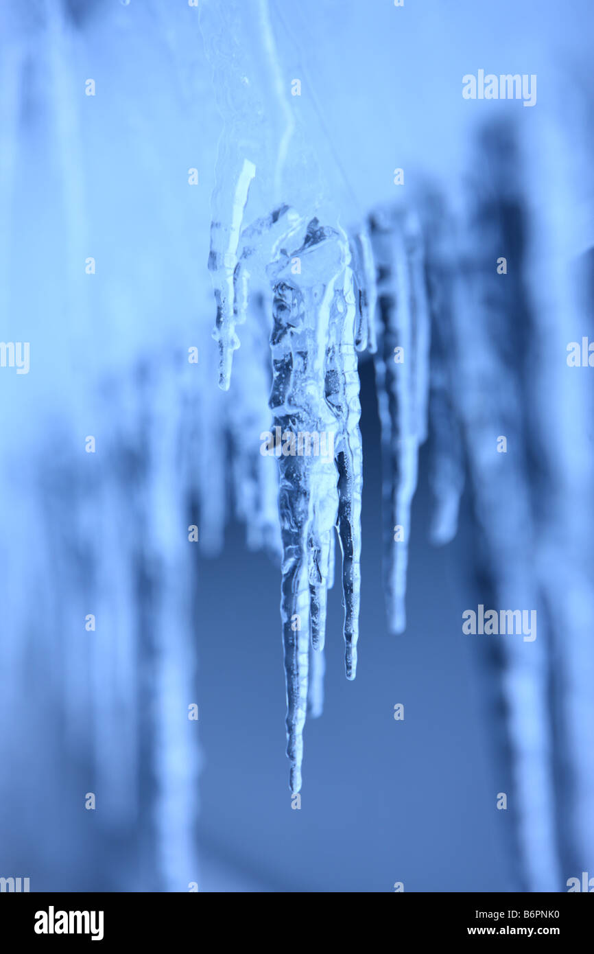 Selective focus Icicles hanging on home exterior Stock Photo