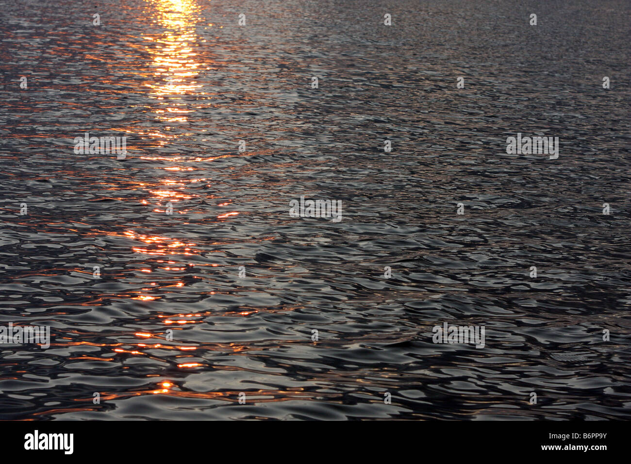 Reflection of the sun as it rises in the Mediterranean sea Stock Photo