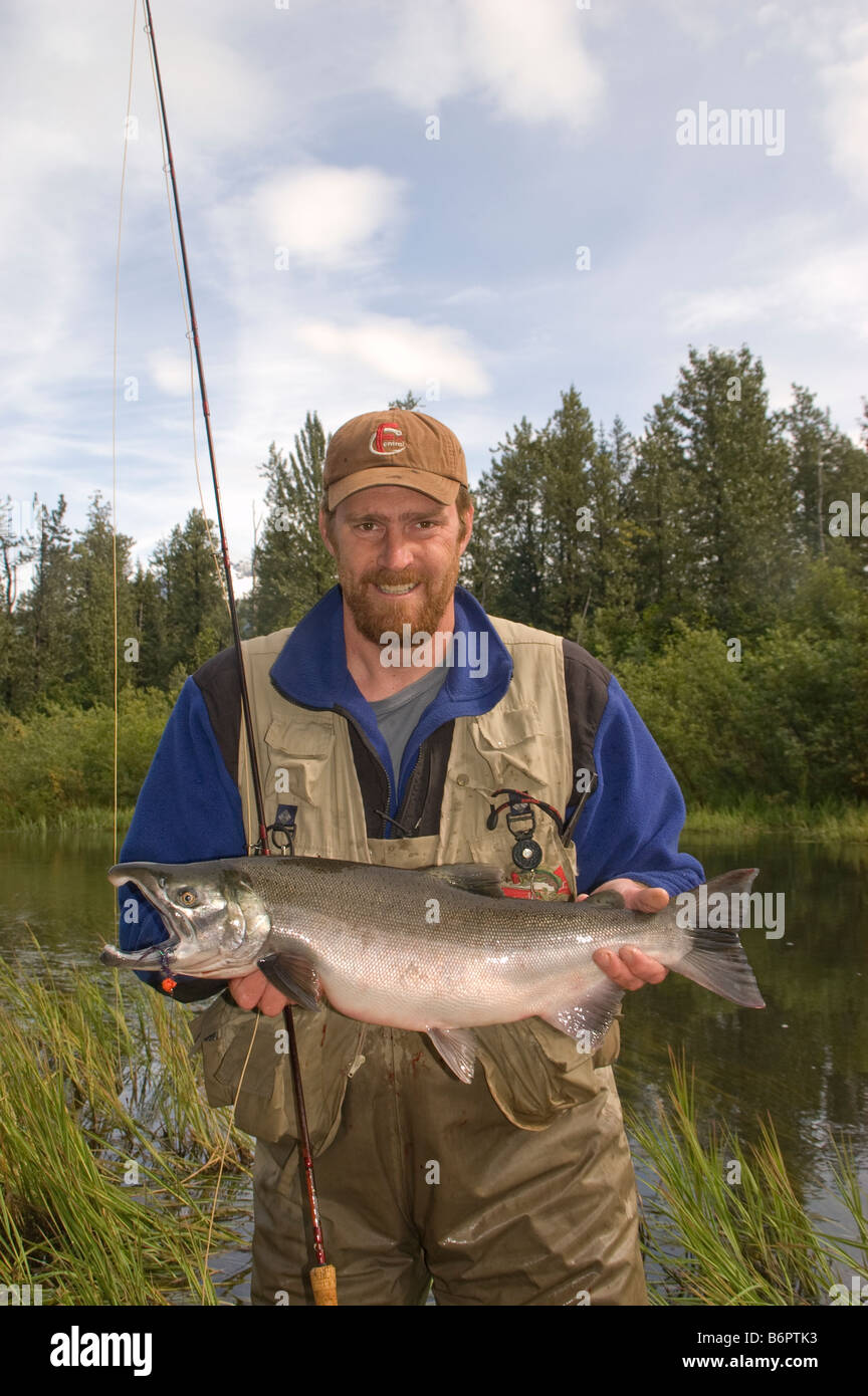 Angler with a Silver salmon caught on the Robe River near Valdez, Alaska  while fly fishing on a river kayaking trip Stock Photo - Alamy