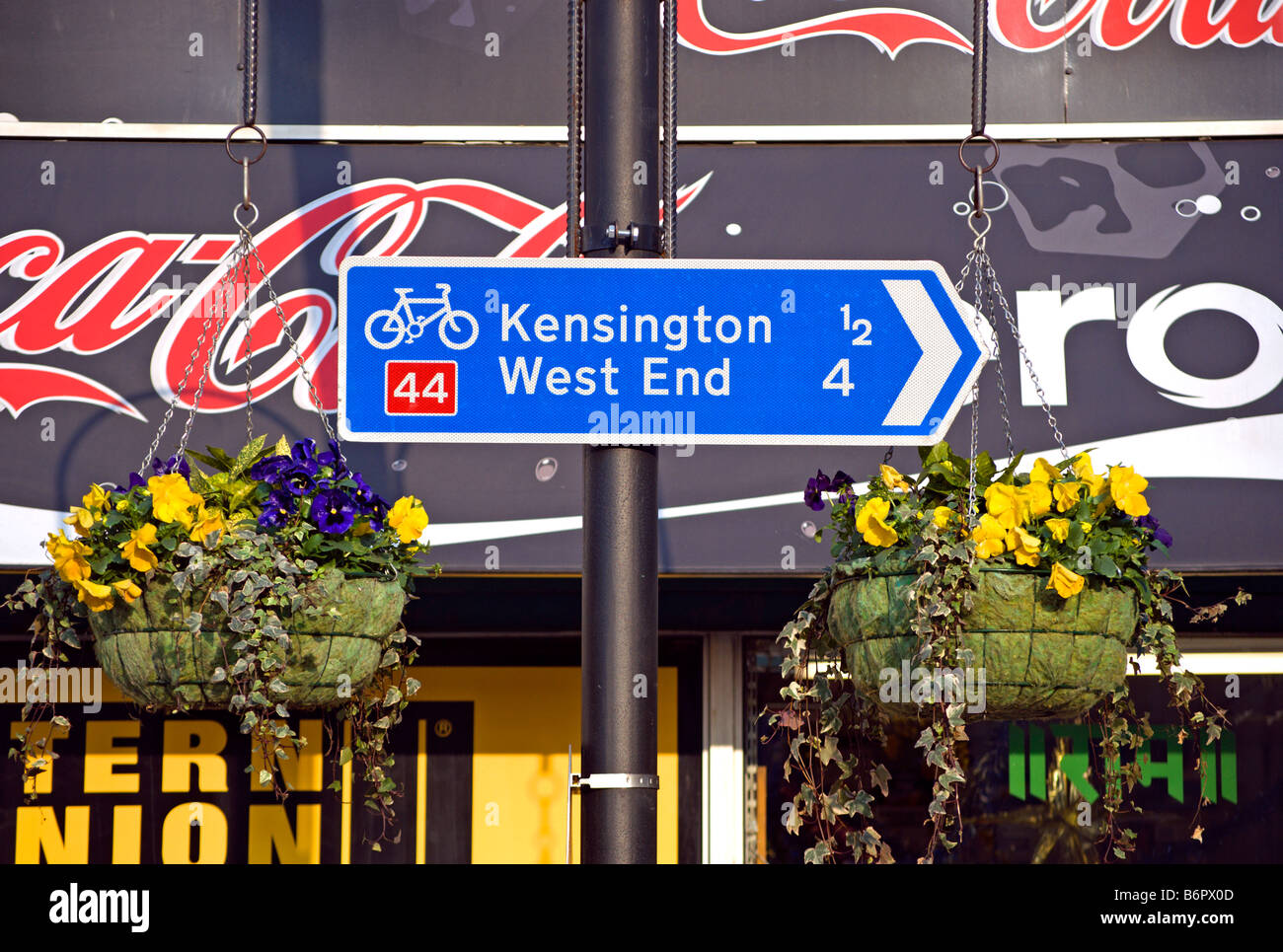 british blue and white cycle route sign with directions and distance to
