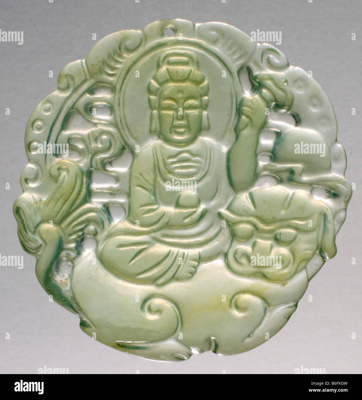 Hand-carved Jade Pendant, showing Buddhist goddess Guan Yin and traditional Chinese Lion Stock Photo