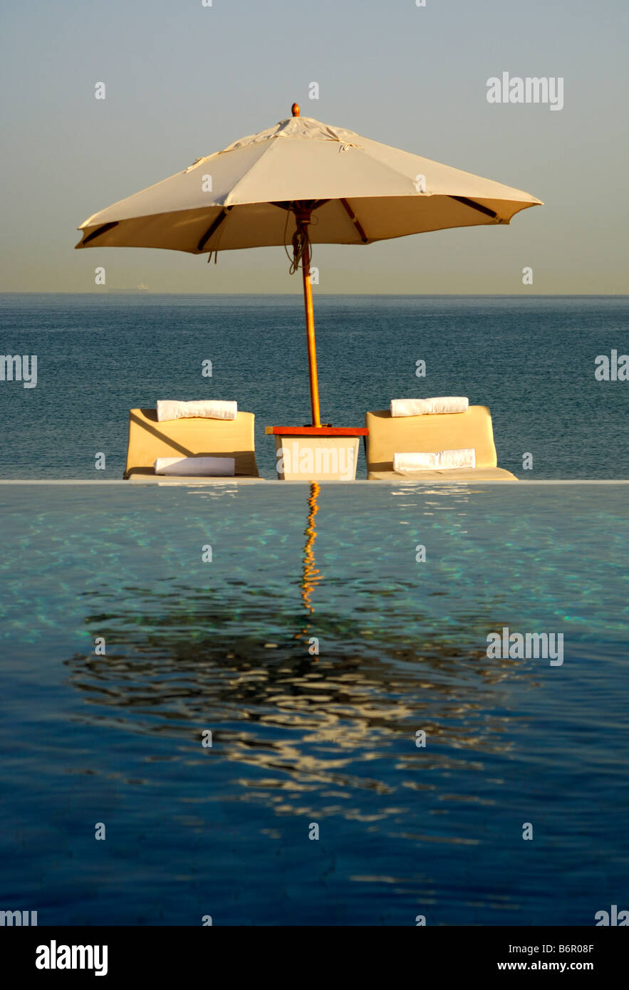 At the Chedi Hotel swimming pool, view across the pool to the sea, Muscat, Sultanate of Oman Stock Photo