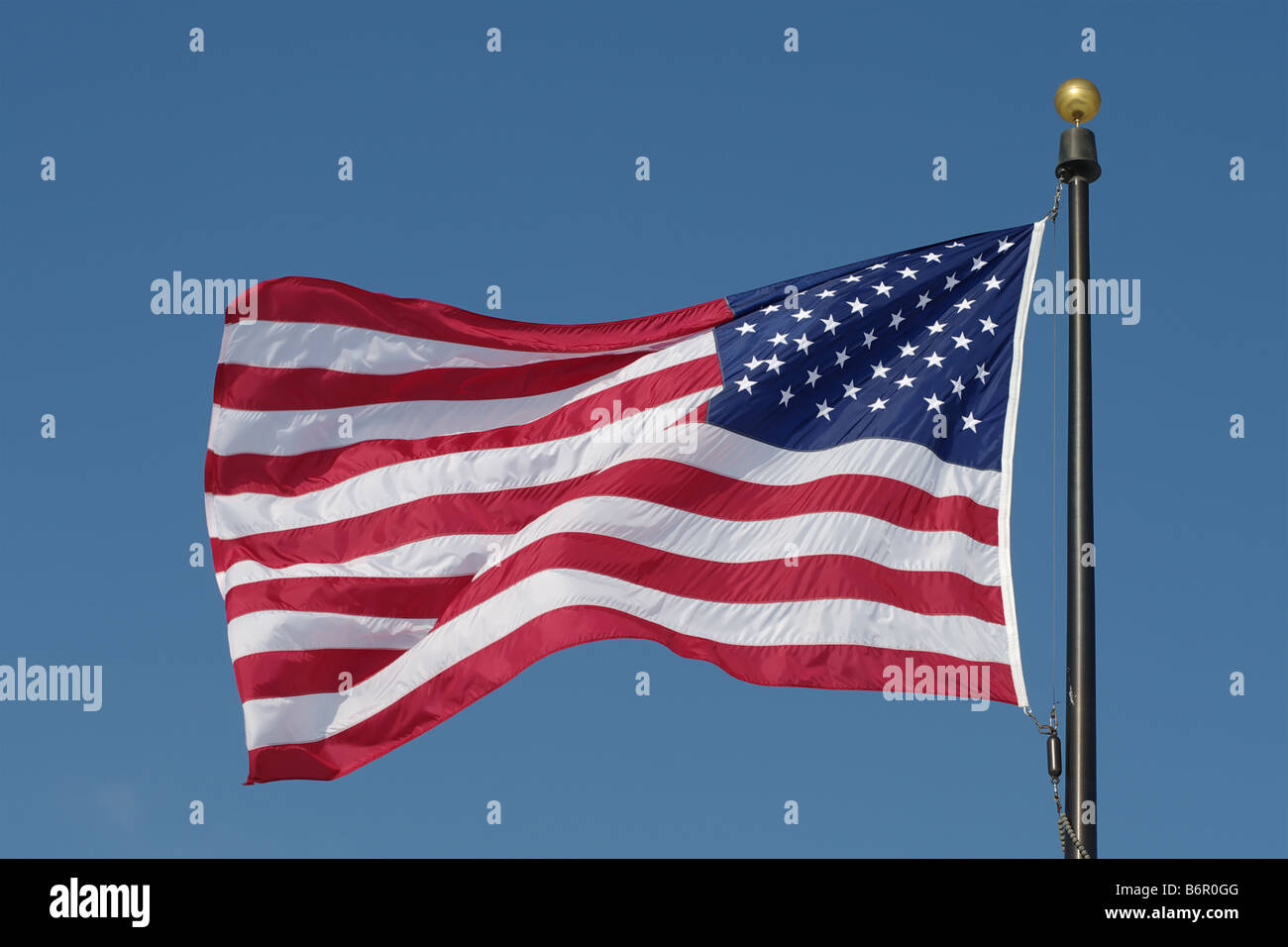 American flag against blue sky Stock Photo - Alamy