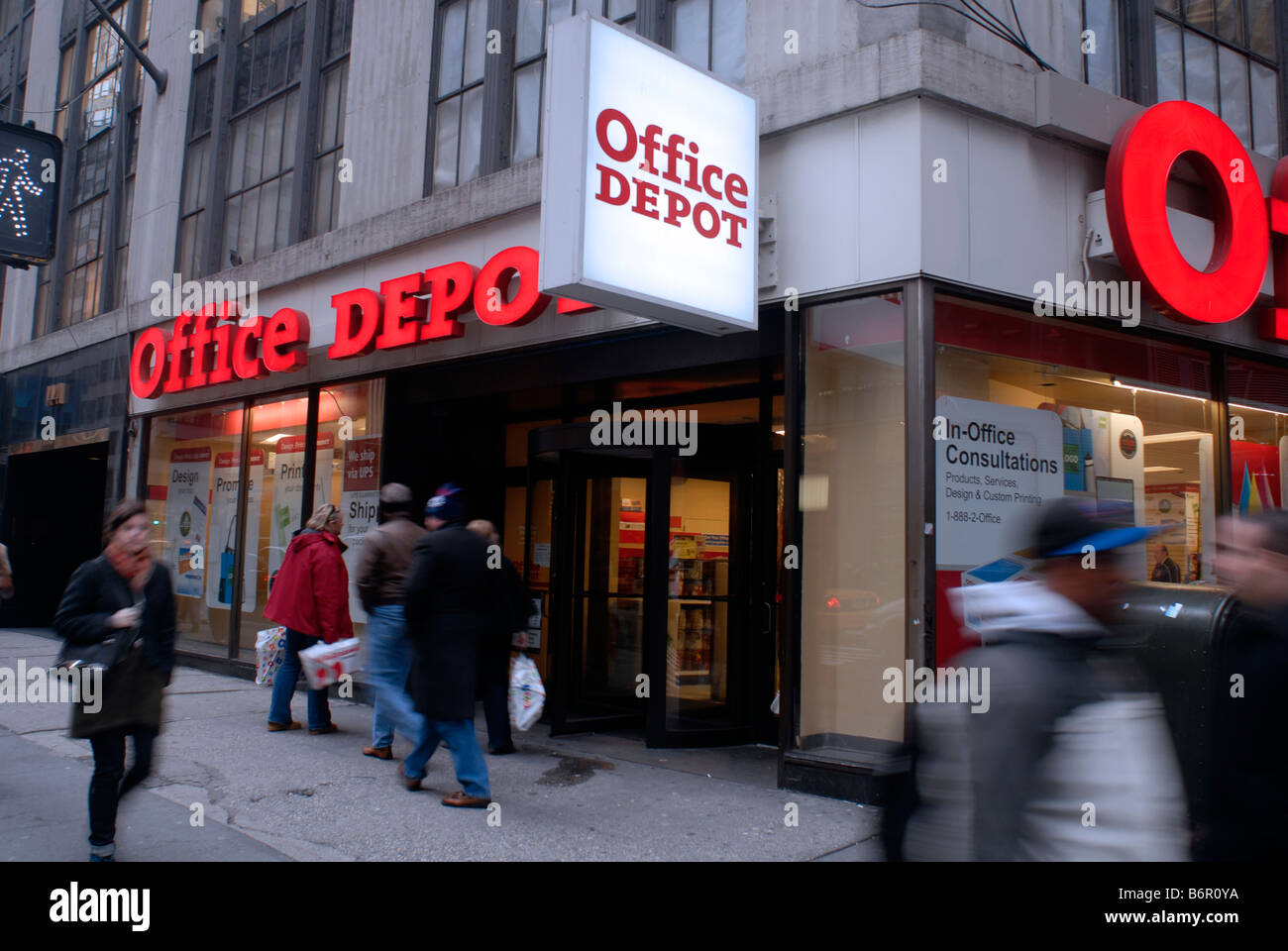 Pedestrians pass an Office Depot store in New York Stock Photo Alamy