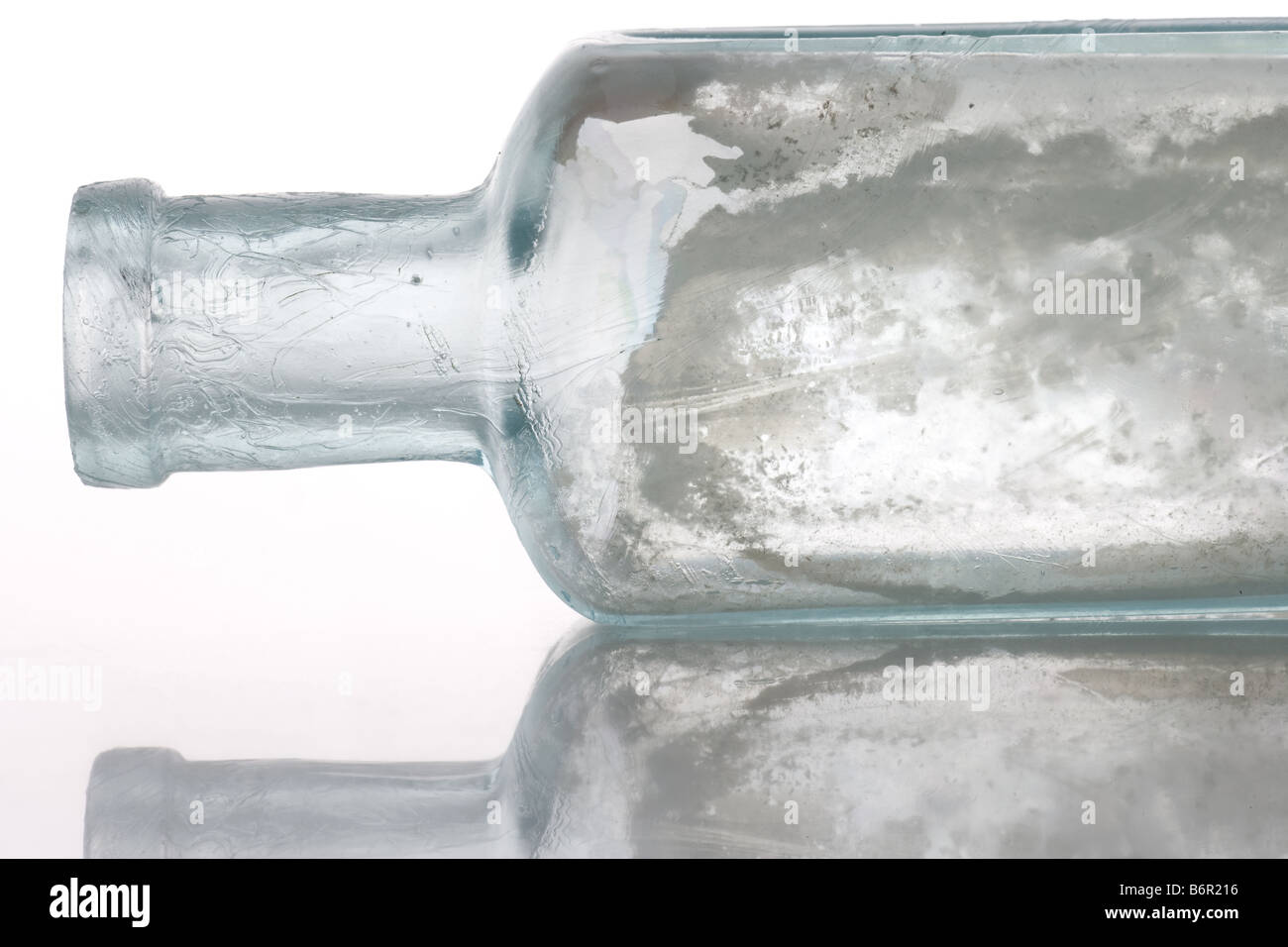 Antique bottle on white table with isolated background Stock Photo - Alamy