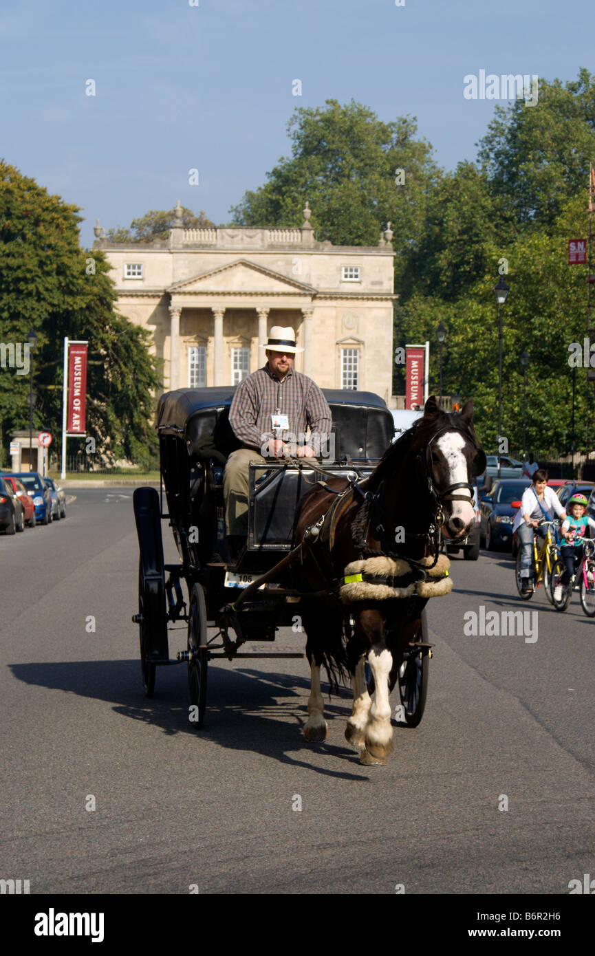horse drawn carriage on great pulteney street with the holburne museum of art in the distance bath somerset Stock Photo