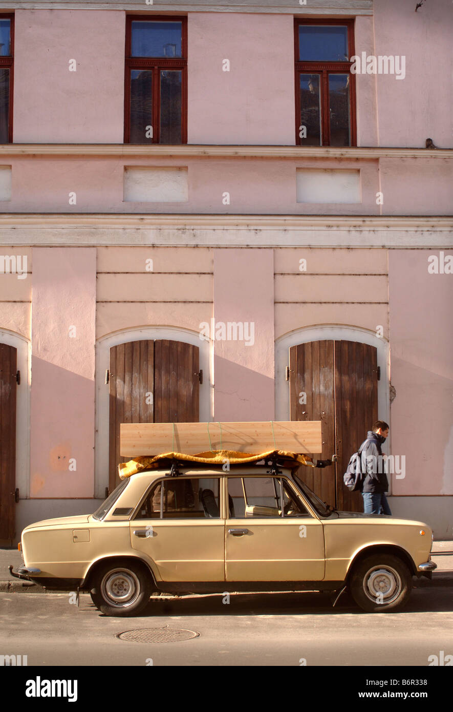 A LADA CAR WITH TIMBER CARRIED ON THE ROOF IN SZEGED HUNGARY Stock Photo