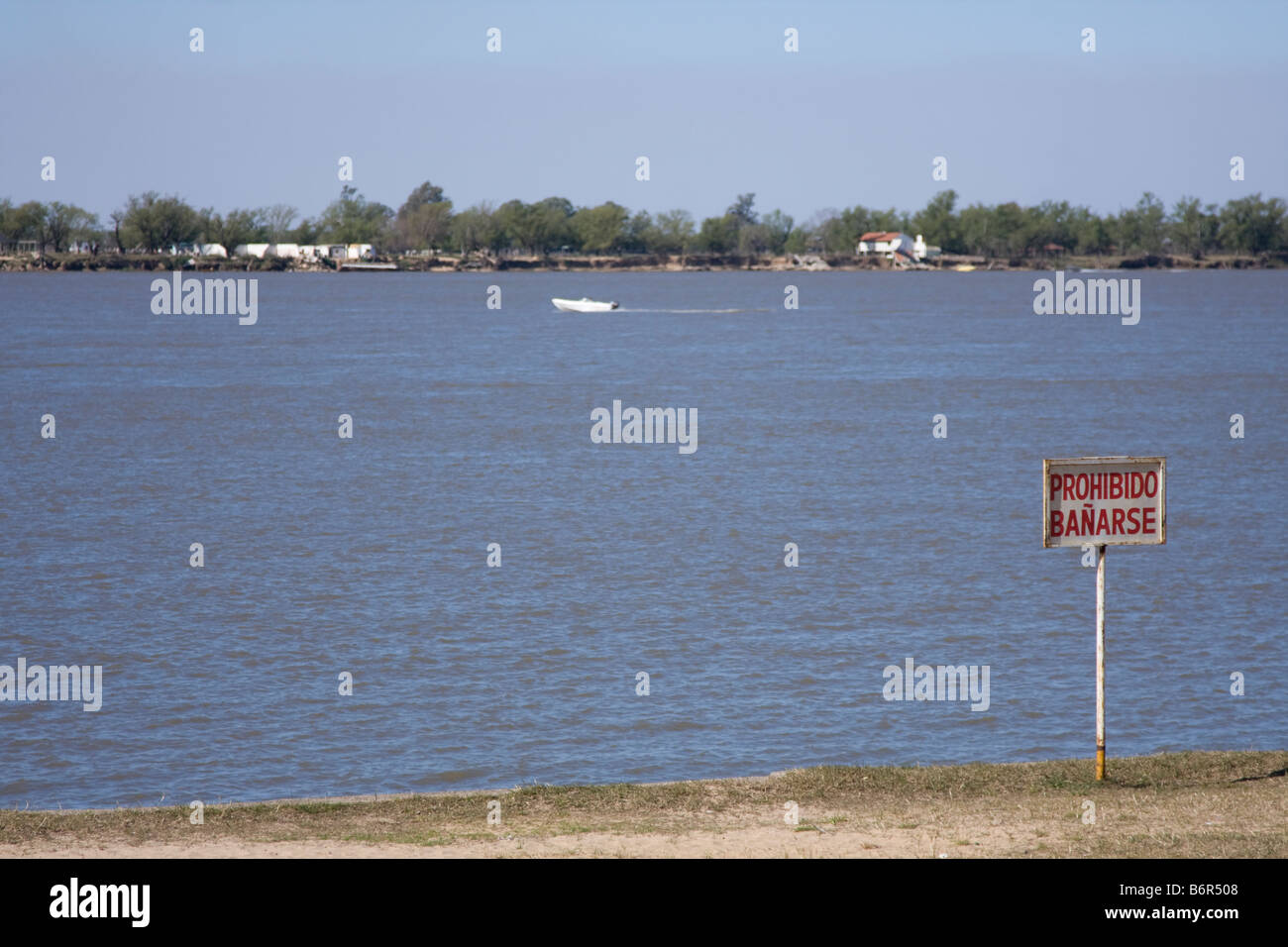 Prohibido bañarse. Swimming Forbidden sign in Parana river. Rosario, Argentina. Stock Photo