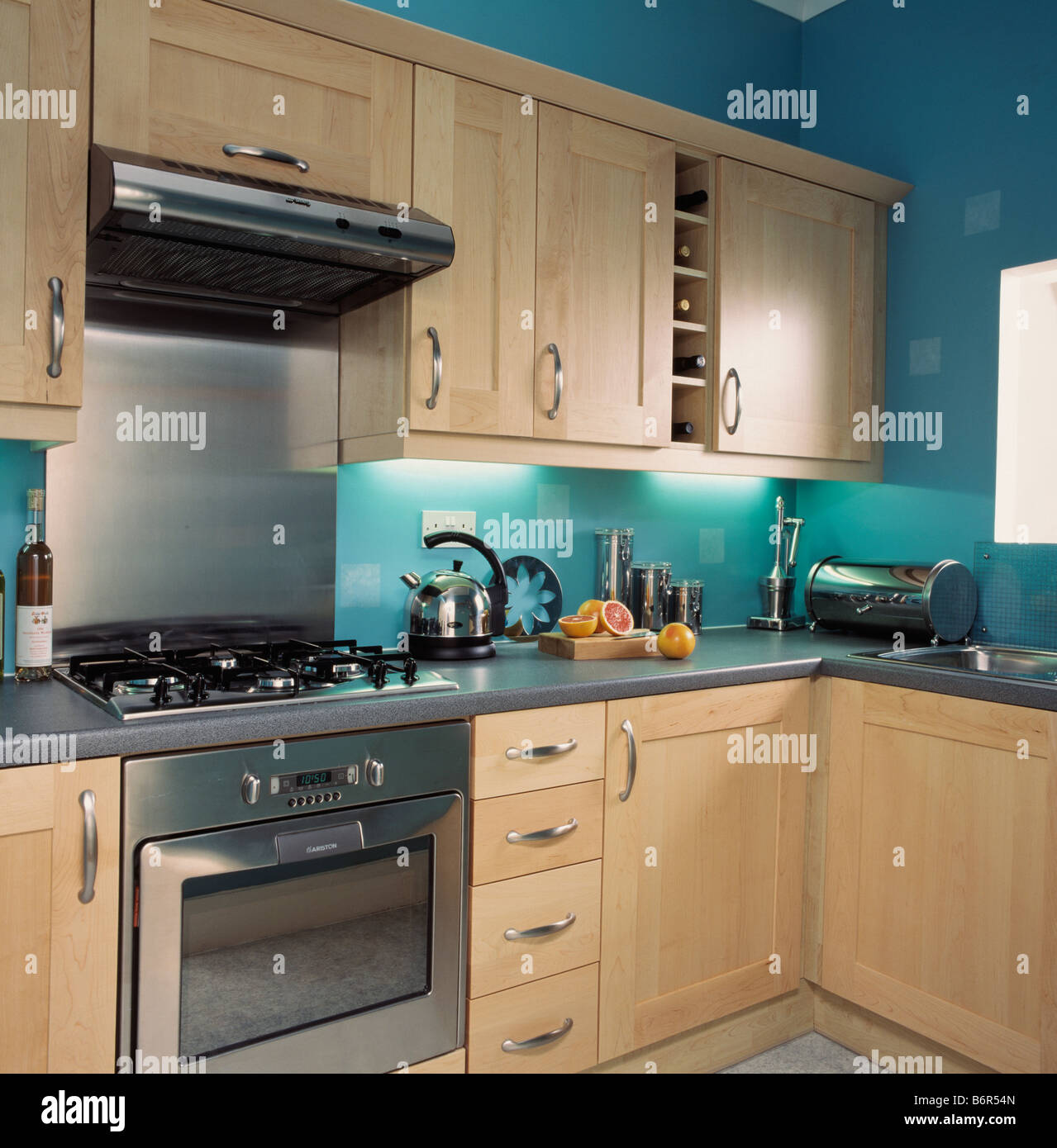 https://c8.alamy.com/comp/B6R54N/stainless-steel-oven-in-turquoise-kitchen-with-pale-wood-units-and-B6R54N.jpg
