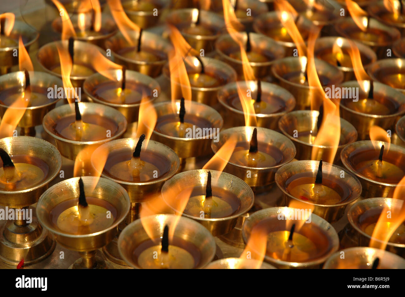 Butter candles burning outside a Tibetan temple in Katmandu Stock Photo