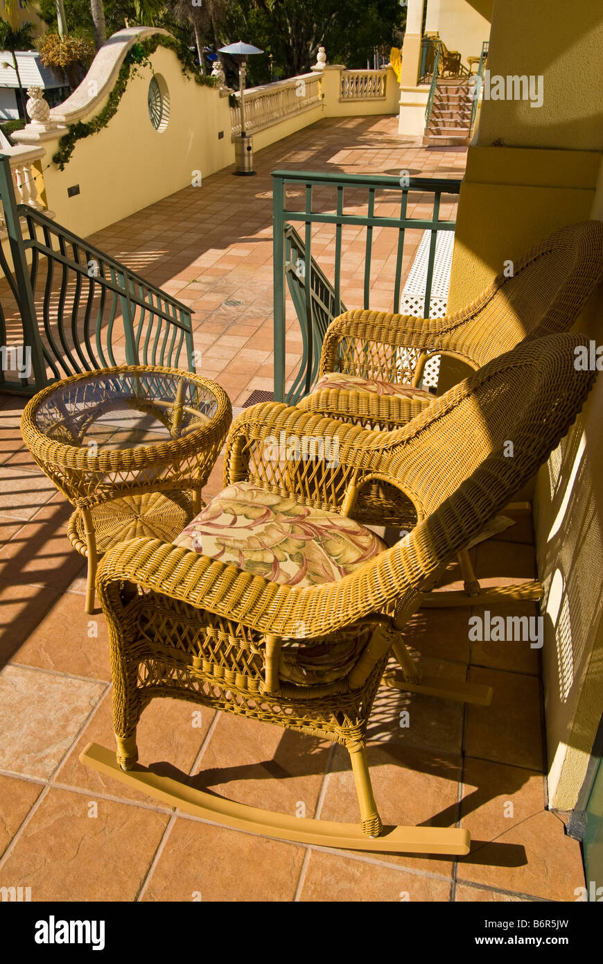 wicker chairs Inn on Fifth terrace balcony porch Old Naples Florida fl popular hotel Stock Photo