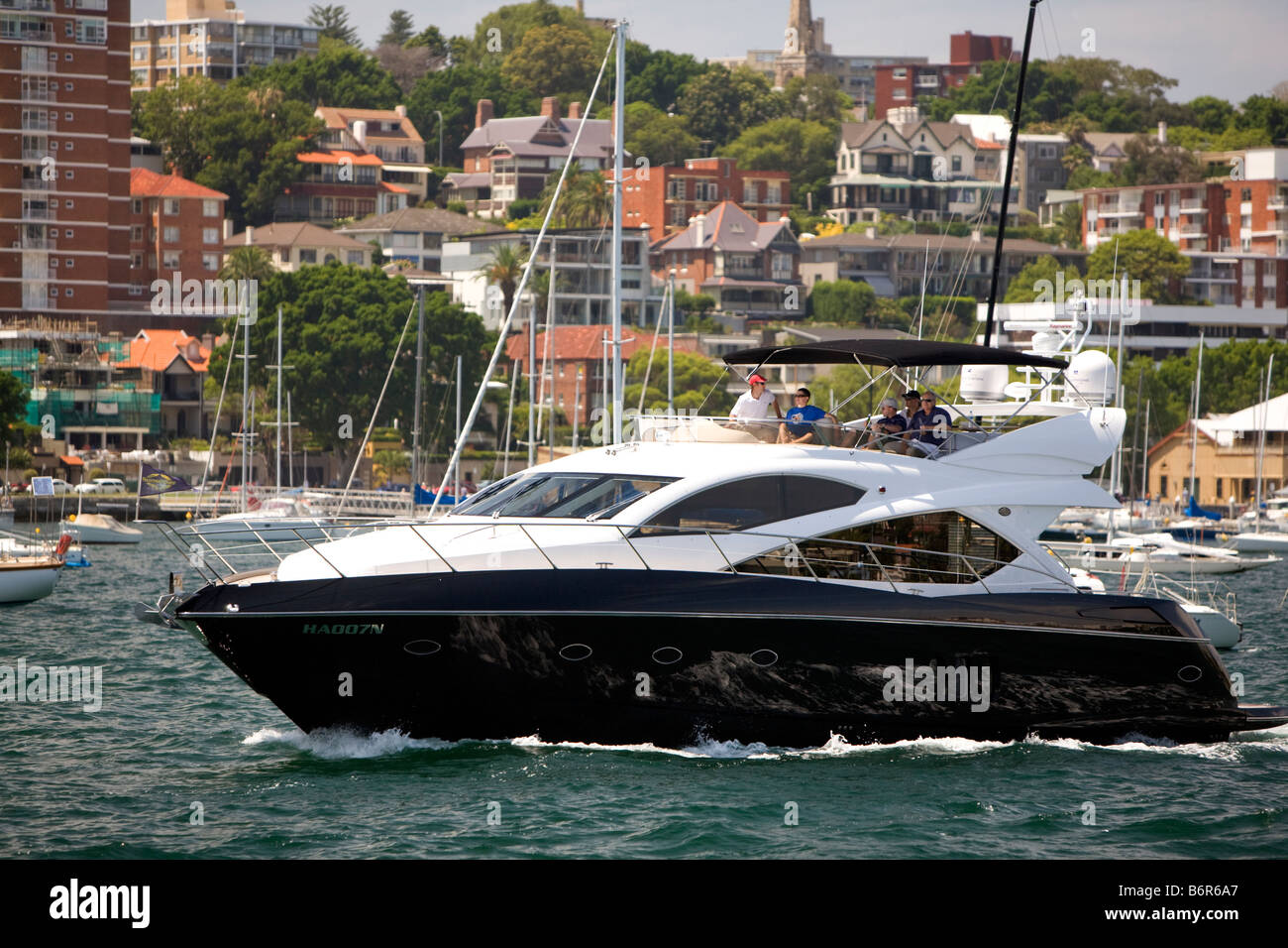 Large luxury blue hulled motor yacht emerges from Rushcutters bay