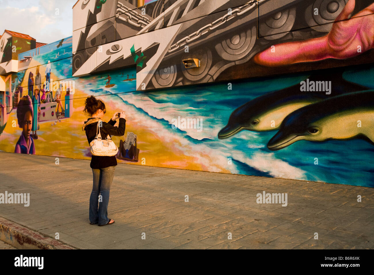 Toursit takes a photo of a mural Venice Beach Los Angeles County California United States of America Stock Photo