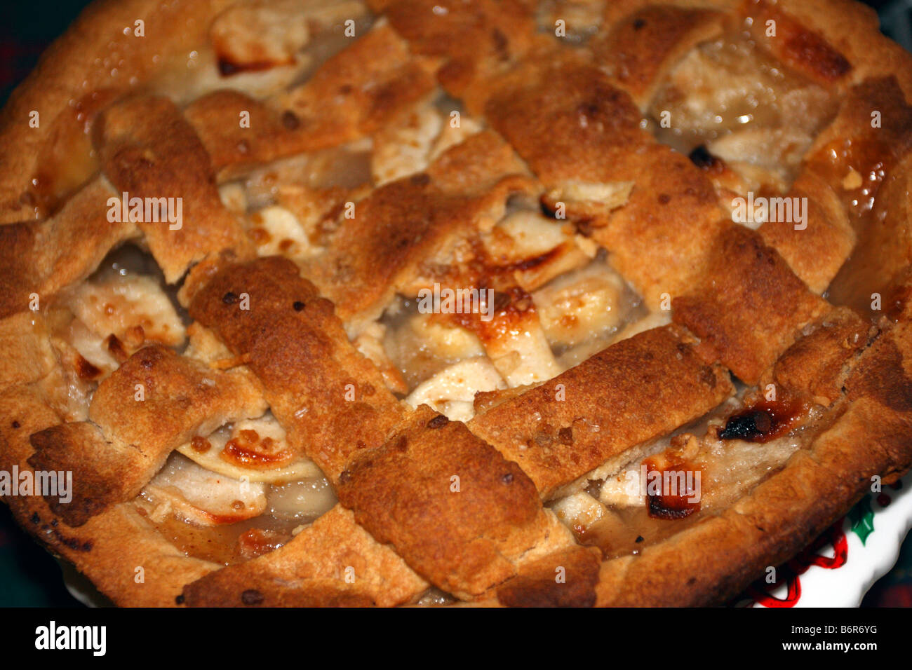 Browned apple pie crust, showing apple slices. Stock Photo
