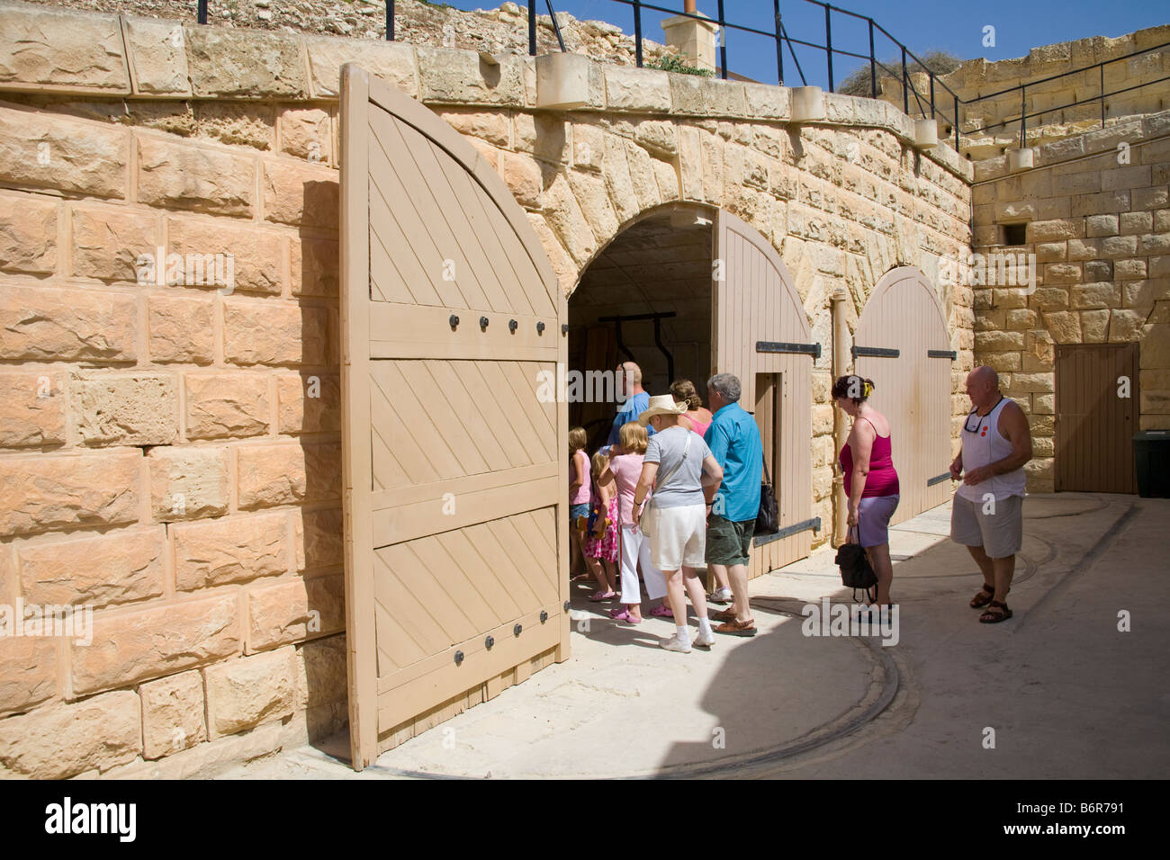 Tourists entering a building at Fort Rinella, Fort Rinella, Kalkara, Malta Stock Photo