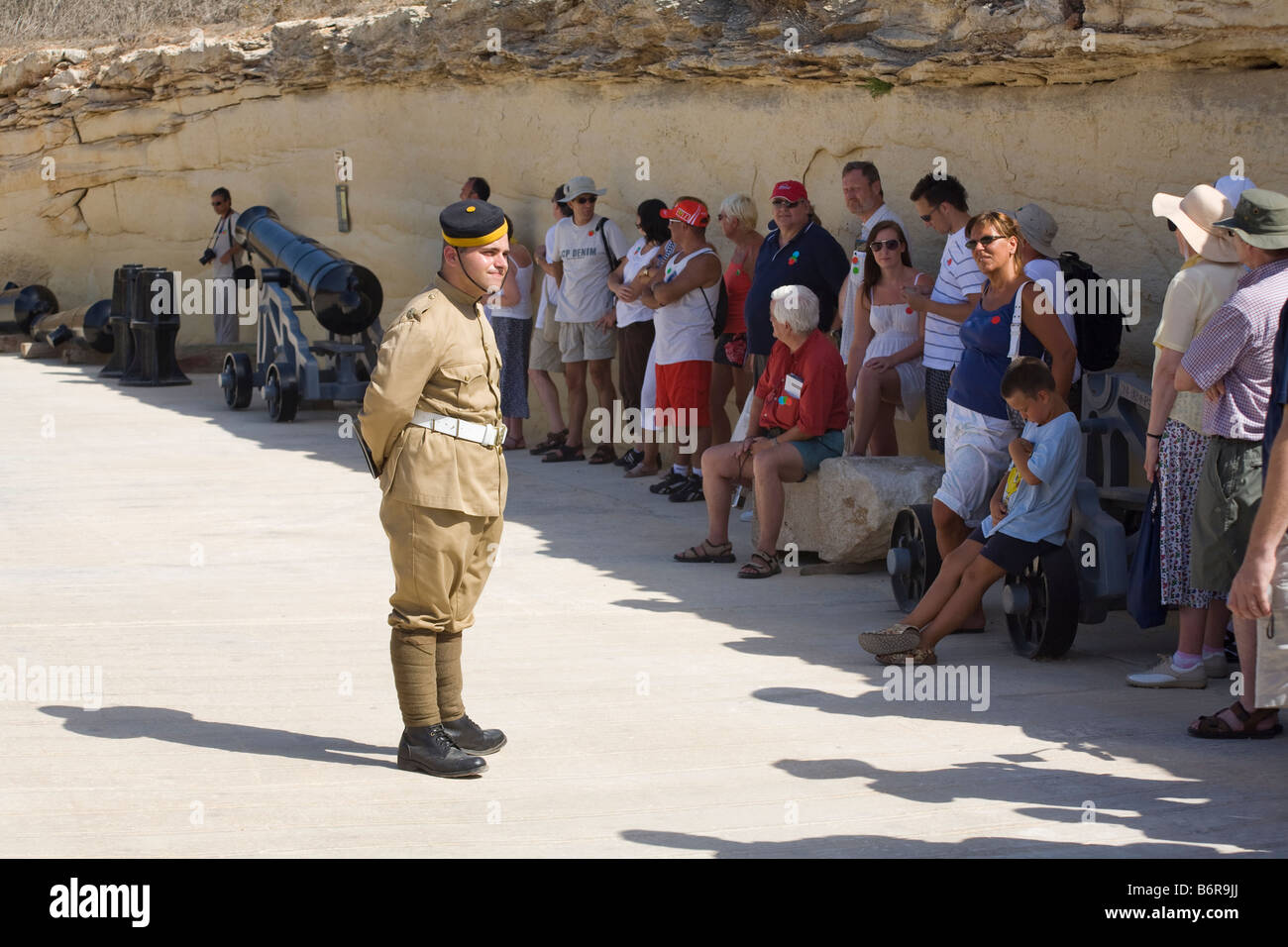 Soldier speaking to a group of tourists, Fort Rinella, Kalkara, Malta Stock Photo