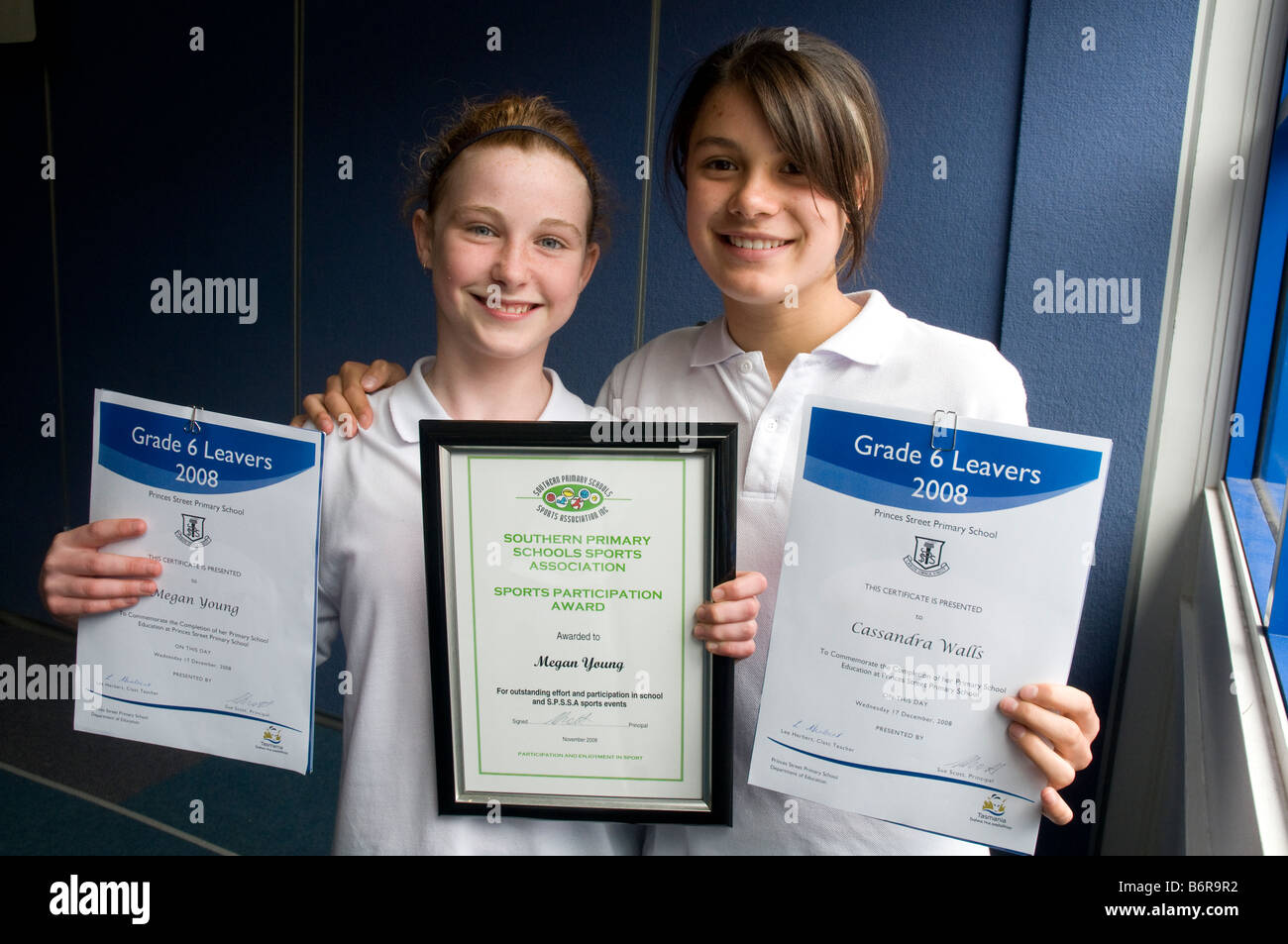 Two Australian primary school graduates with their leaving certificates Stock Photo