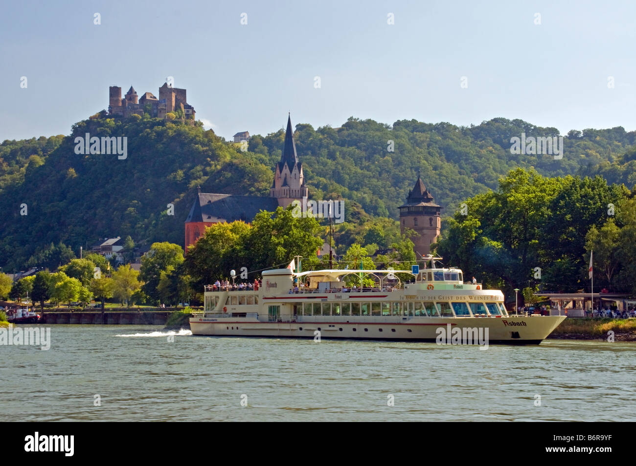 Oberwesel on Rhine River with river cruise ship, Schonburg Castle ruins on hill above town Stock Photo