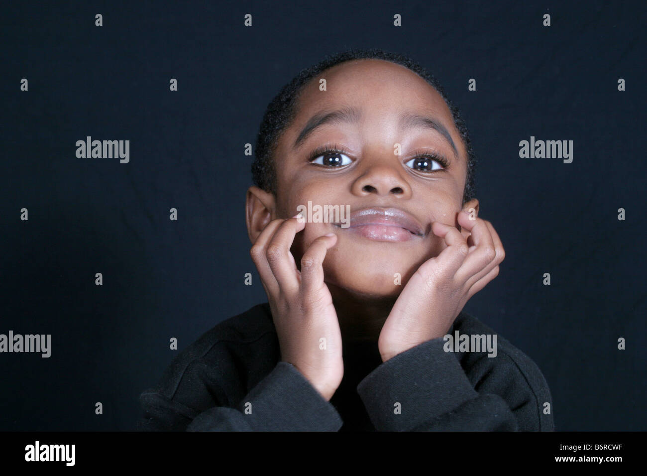 Thoughtful and cute African American boy Stock Photo - Alamy