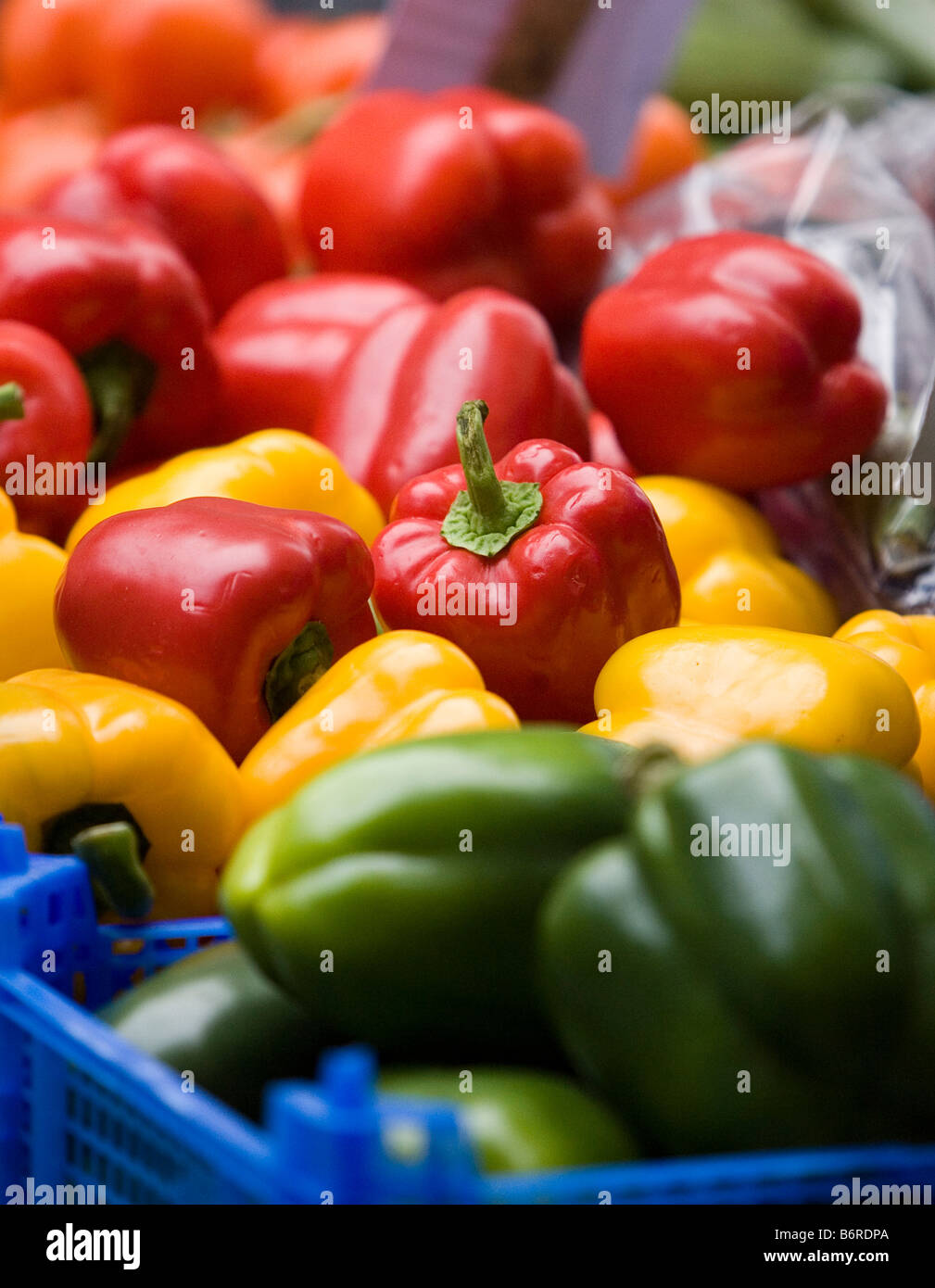 Red green and yellow peppers on a market stall Stock Photo - Alamy