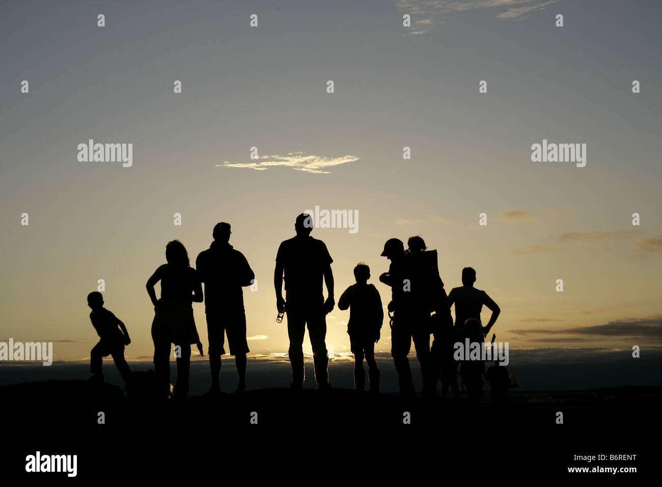 Silhouette of a group of people on a hill top at sunset Stock Photo - Alamy