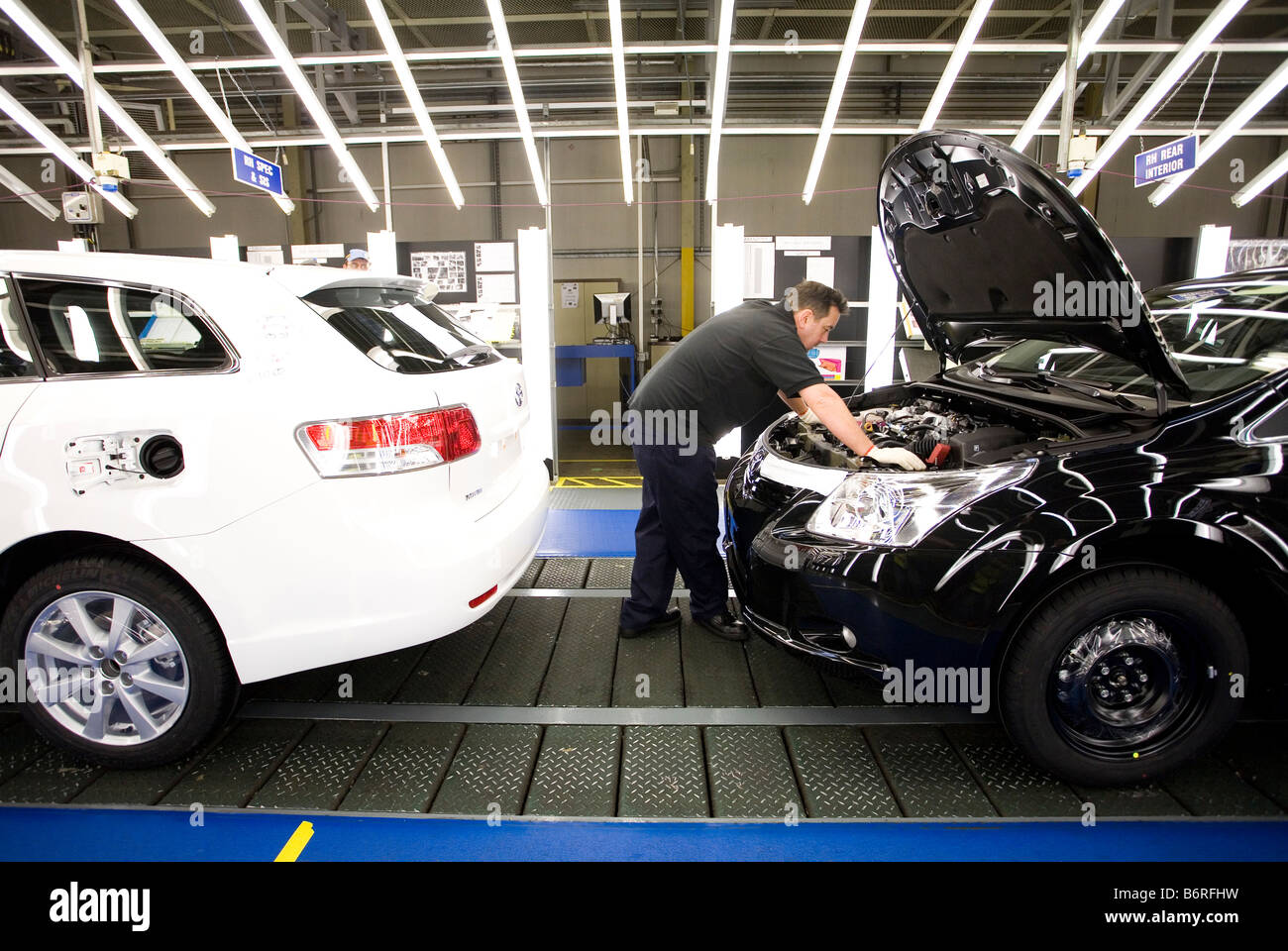 Workers at Toyota Final Assembly production line do a final quality