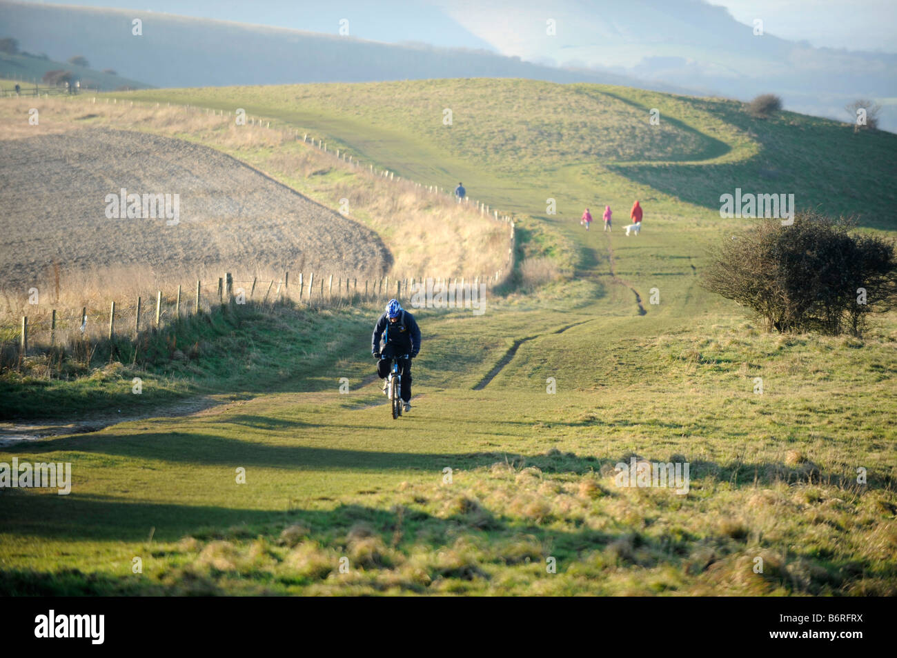Walkers and cyclists on the South Downs at Ditchling Beacon in Sussex UK Stock Photo