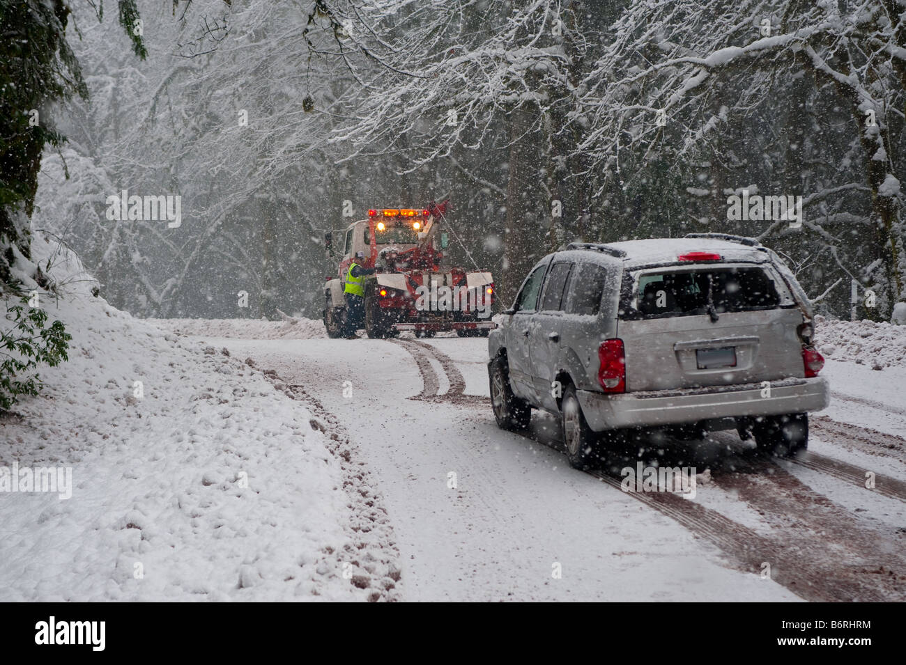 Car being towed after accident in snow storm Stock Photo Alamy