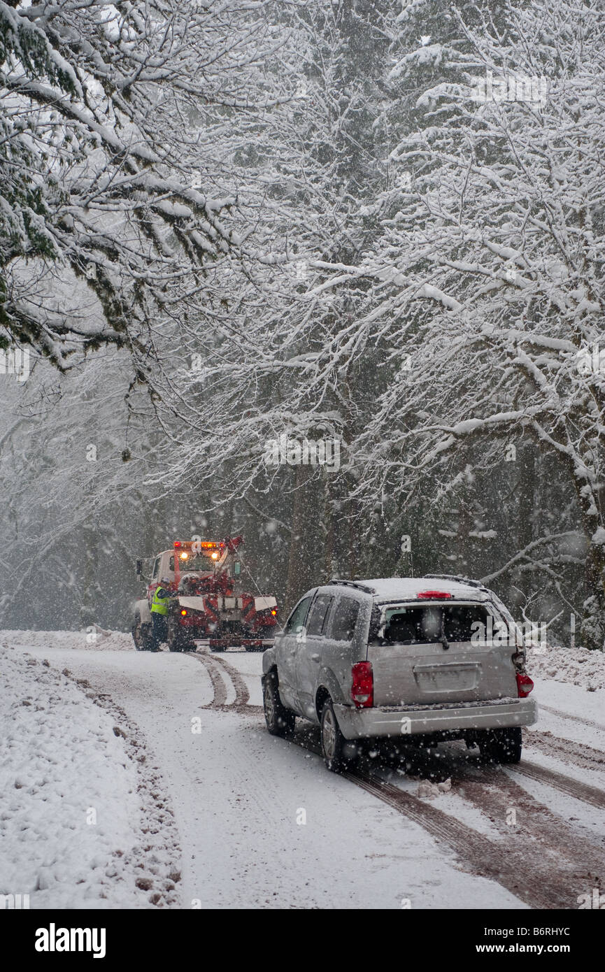 Car being towed after accident in snow storm Stock Photo - Alamy