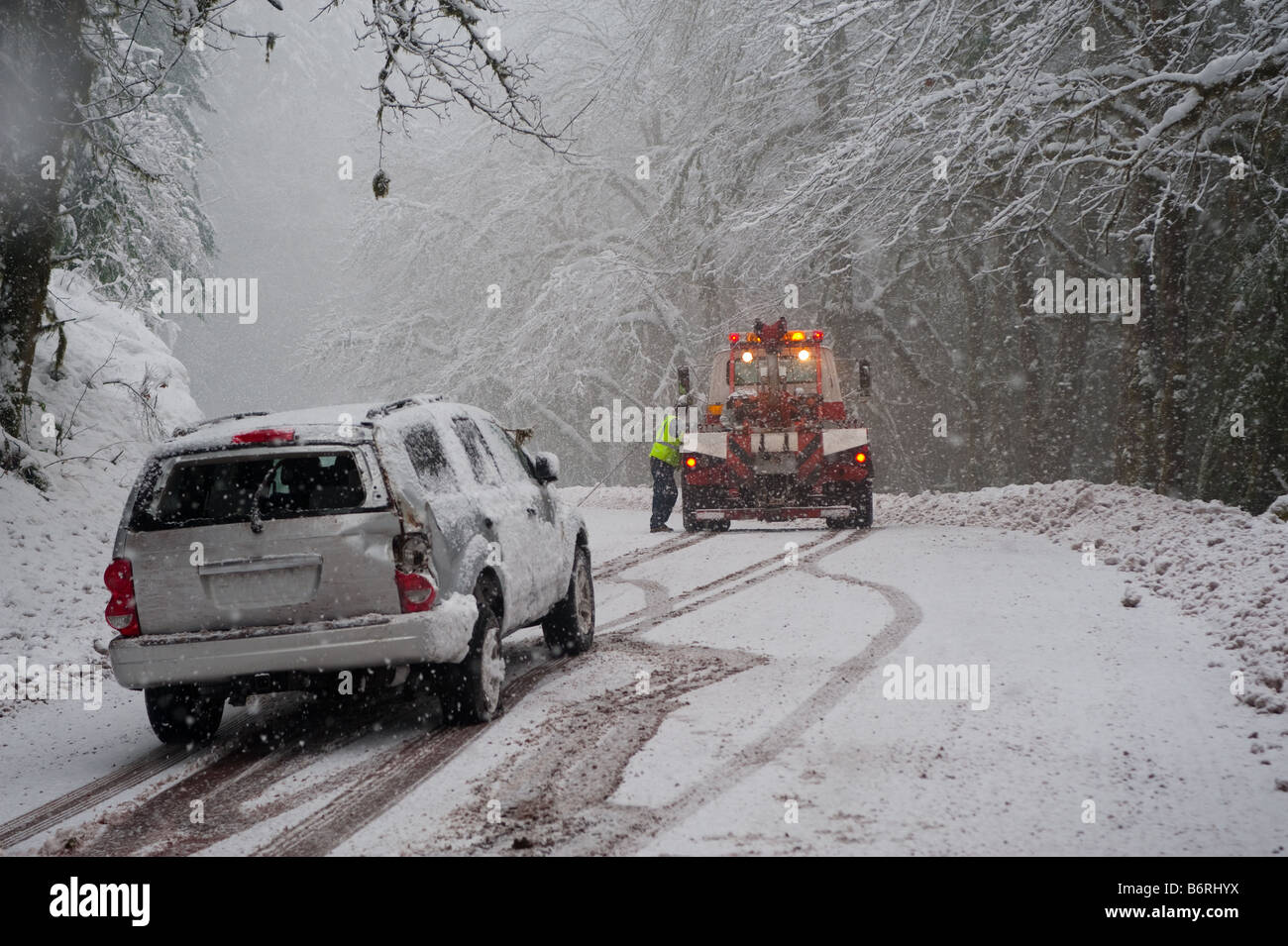 Car being towed after accident in snow storm Stock Photo Alamy