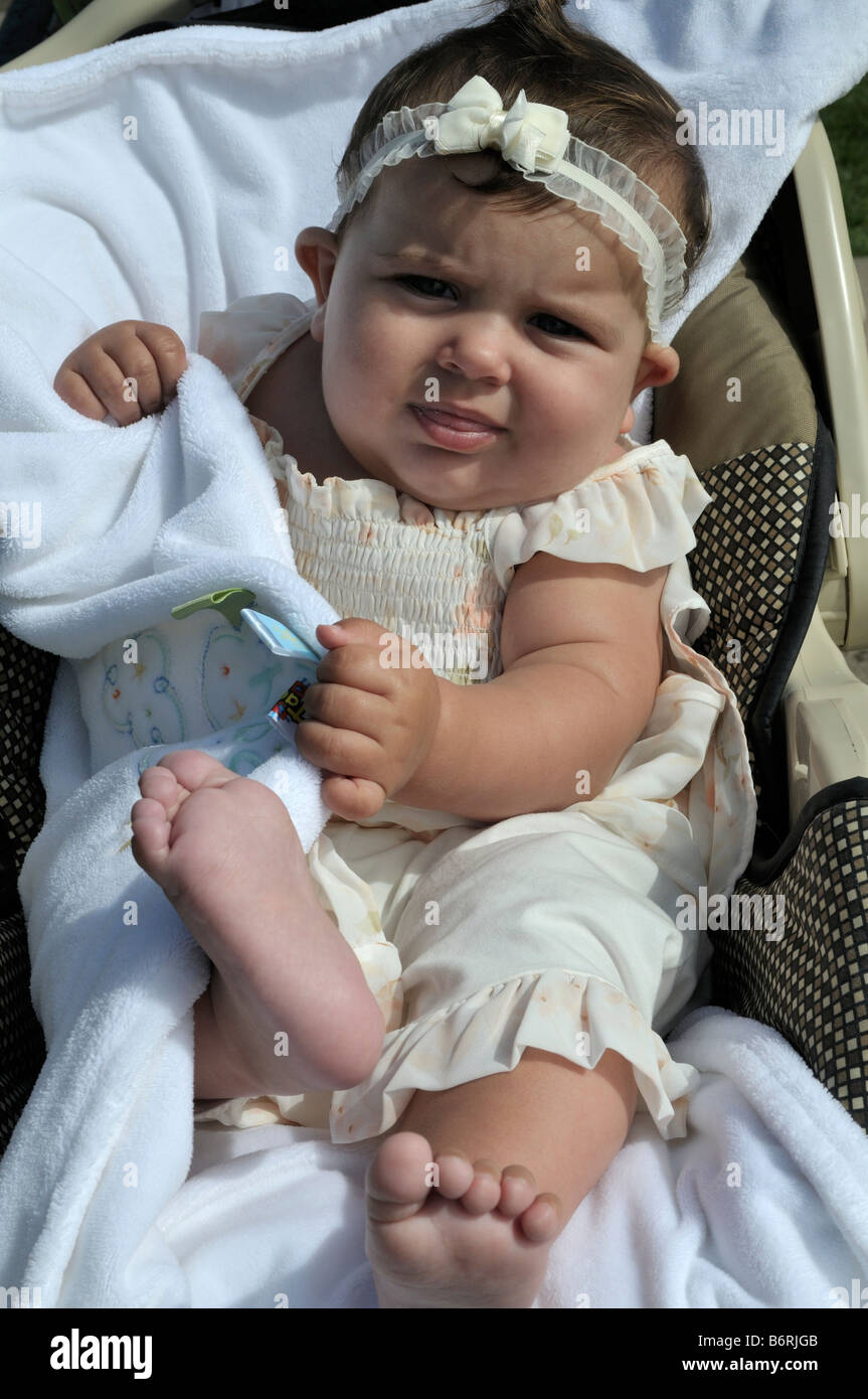 American baby girl resting safely on a white blanket Stock Photo Alamy