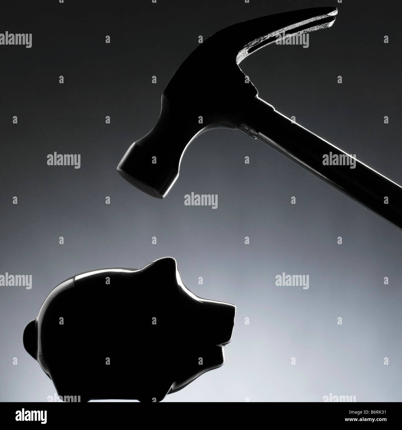 claw hammer coming down on a piggy bank silhouette Stock Photo - Alamy