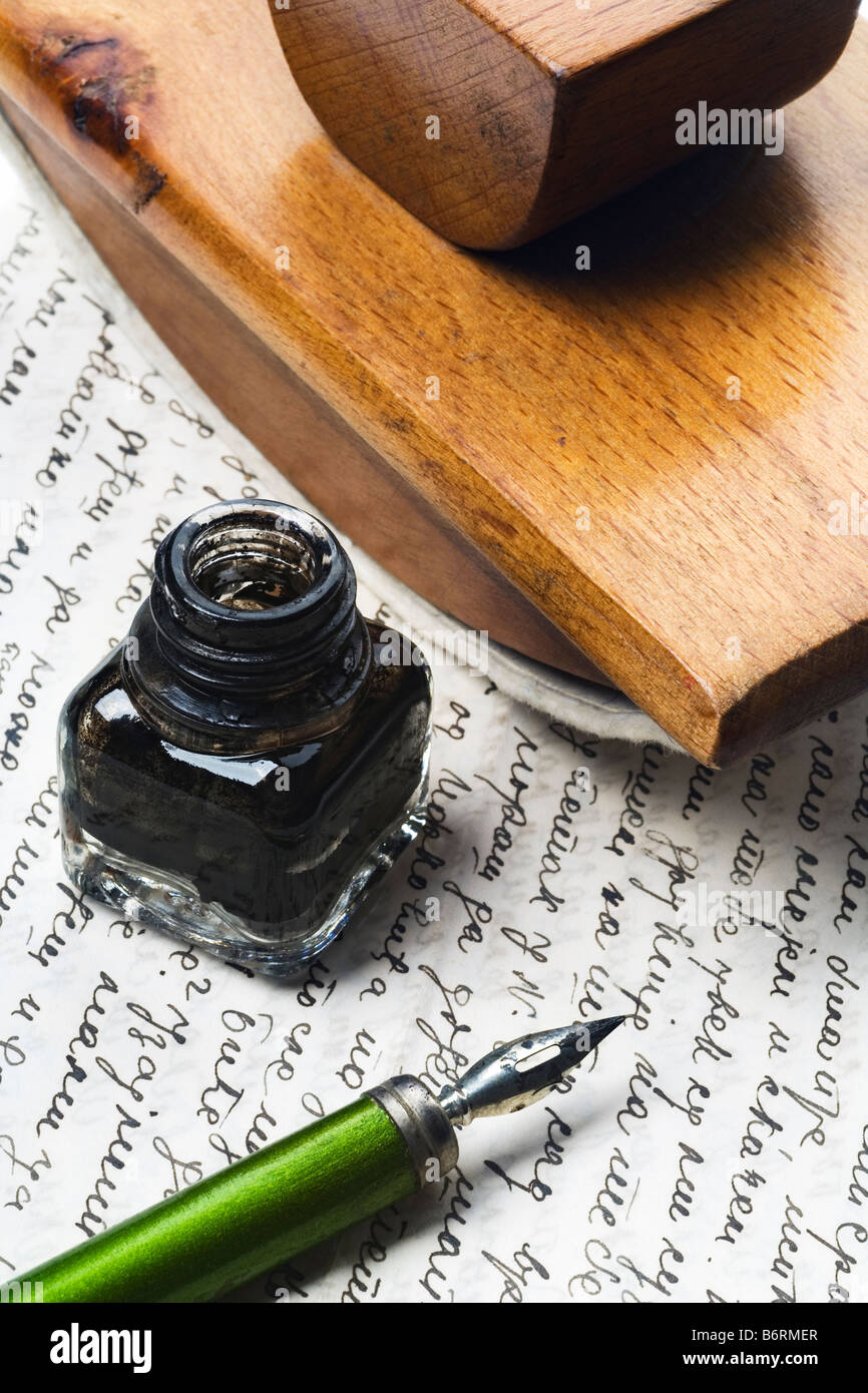vintage writing tools nib ink bottle and an ink dryer on a letter