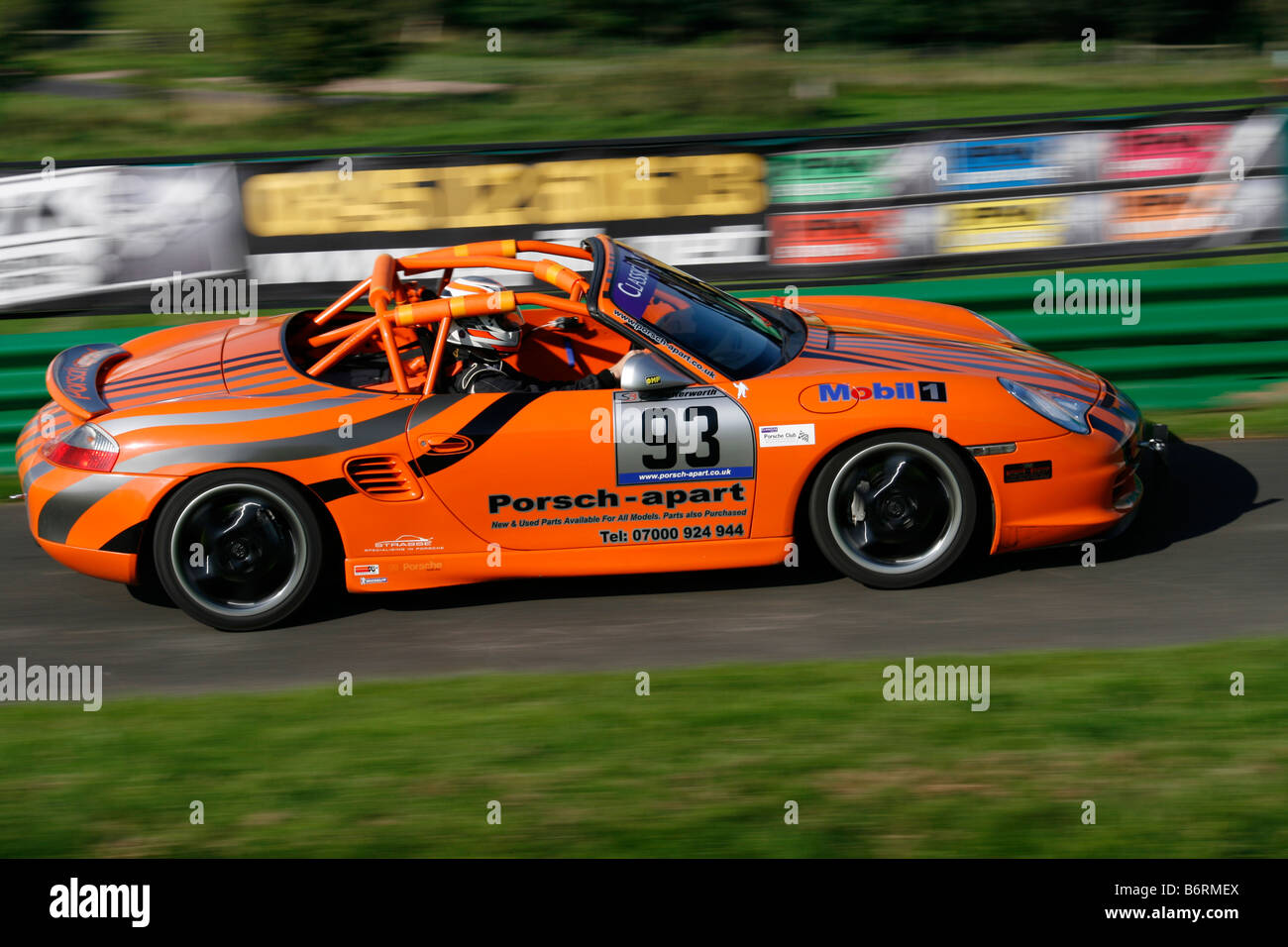 Simon Butterworth driving a Porche Boxter, speeding to the finish line