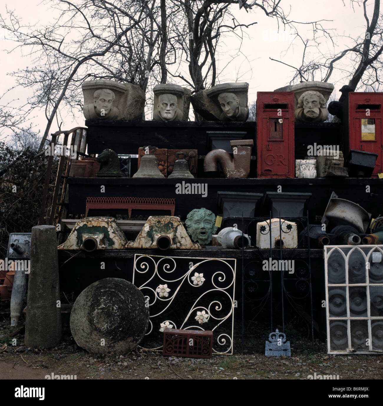 Old garden gates and statues with post boxes in reclamation yard Stock
