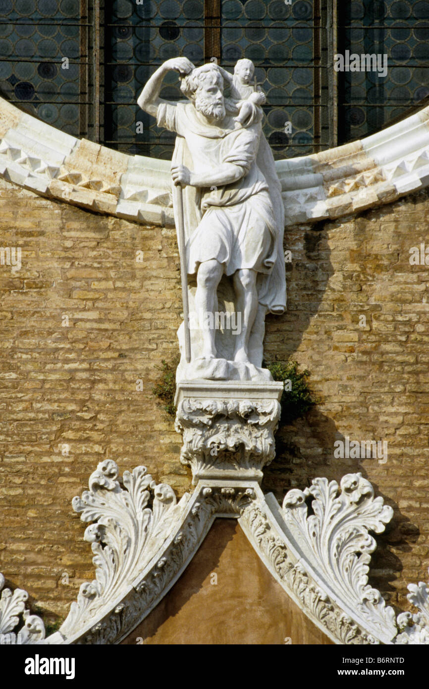 Venice Italy Statue of St Christopher stands over the main door of the Church of Madonna dell Orto Cannaregio Stock Photo