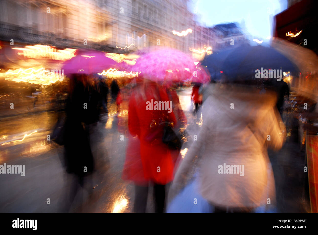 Shoppers with umbrellas in rainy London street Stock Photo Alamy