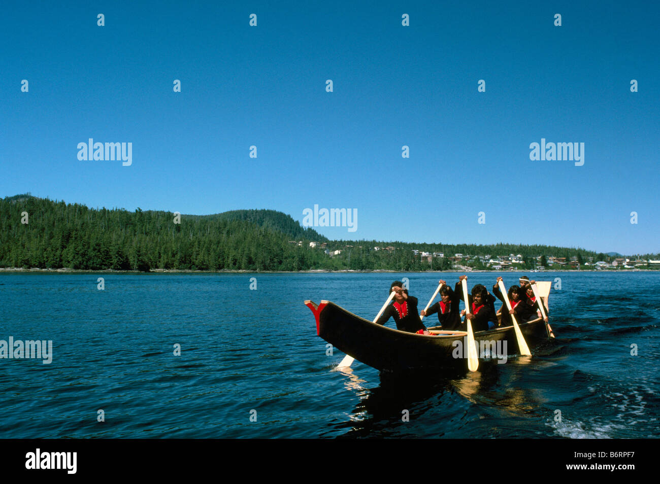 Native American Indians canoeing in a Traditional Dugout Canoe near ...