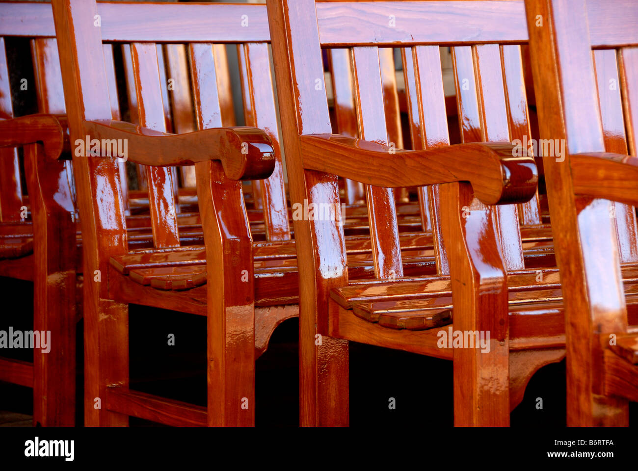 A row of wooden chairs Stock Photo Alamy