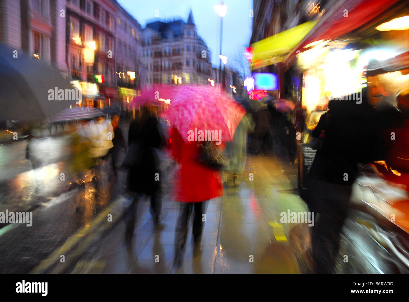 Rainy London street with shoppers and umbrellas Stock Photo Alamy