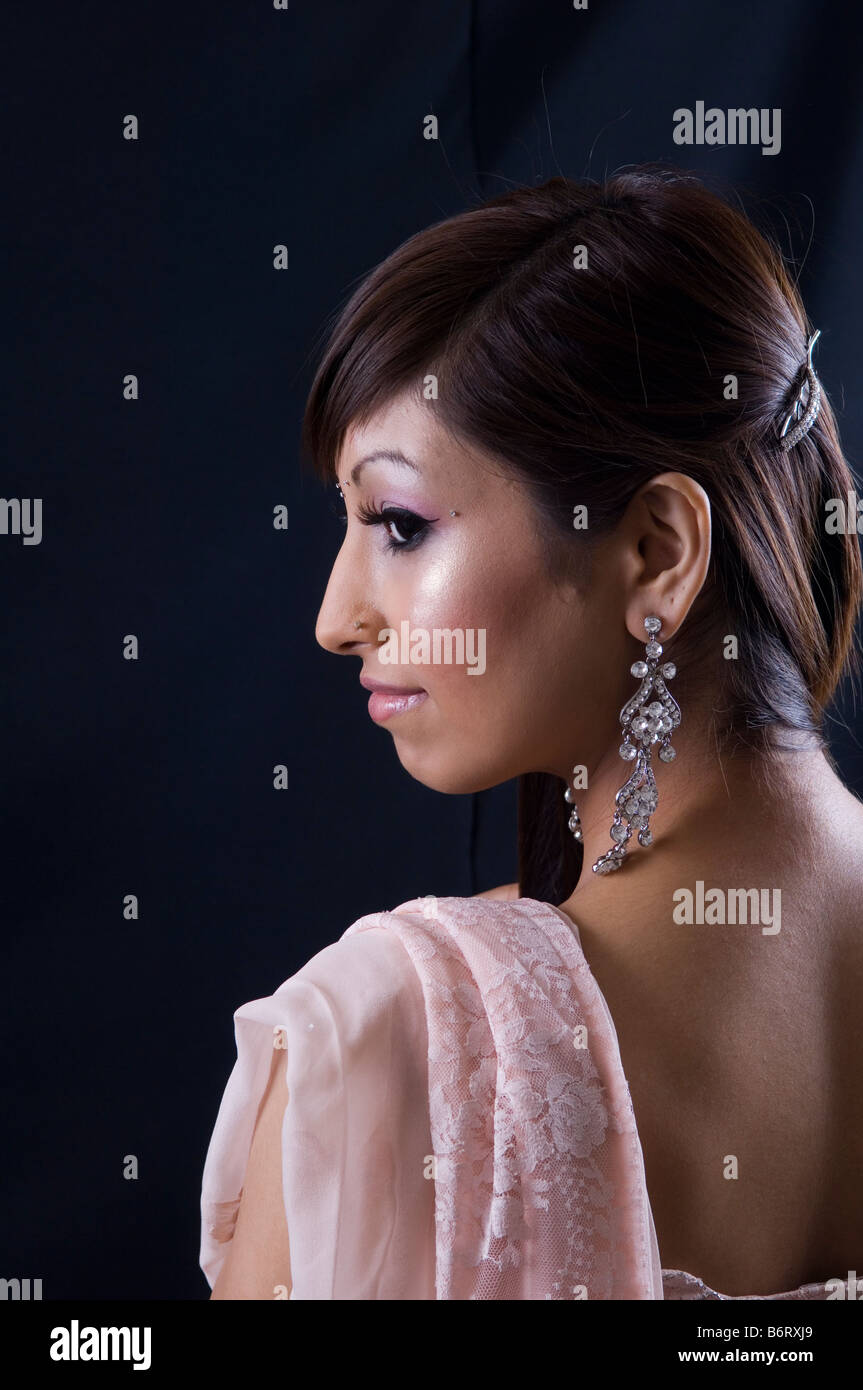 Beautiful young Asian woman daydreaming Stock Photo