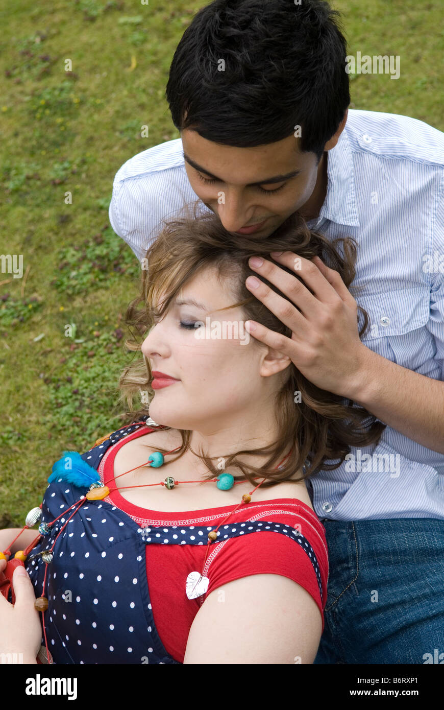 Man embracing woman in the park Stock Photo - Alamy