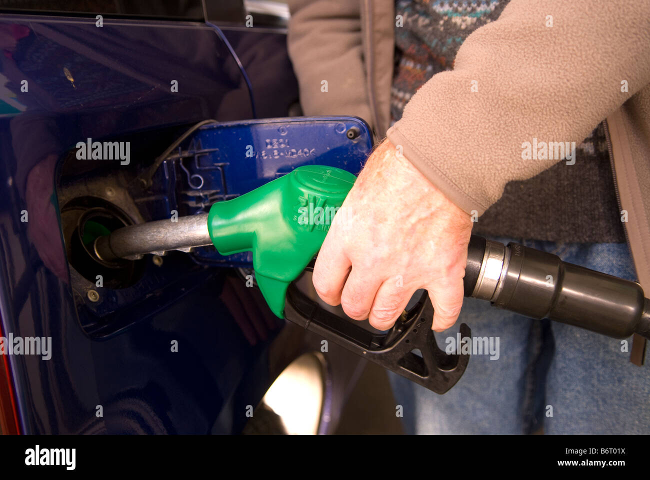 73 year old ex pat Englishman filling up car with petrol at a station in Castell De Ferro, Granada, Andalucia, southern Spain. Stock Photo