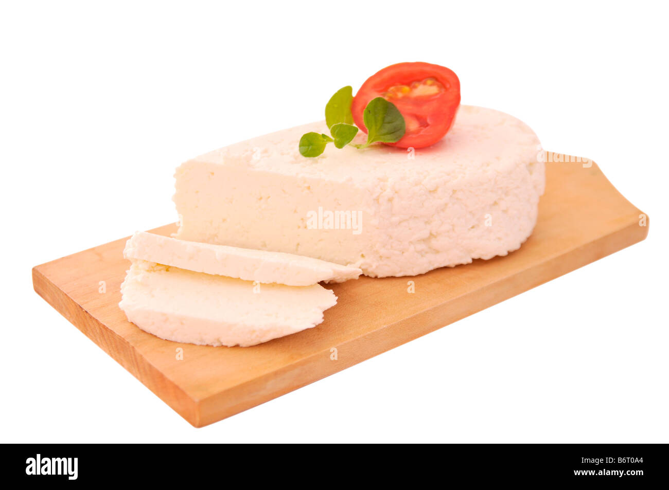 Cottage Cheese Slices On A Wooden Board Decorated With Tomato And