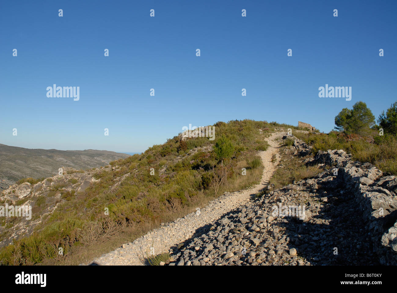 hiking trail and dry stone wall on the Sierra de la Forada, Alicante Province, Comunidad Valenciana, Spain Stock Photo