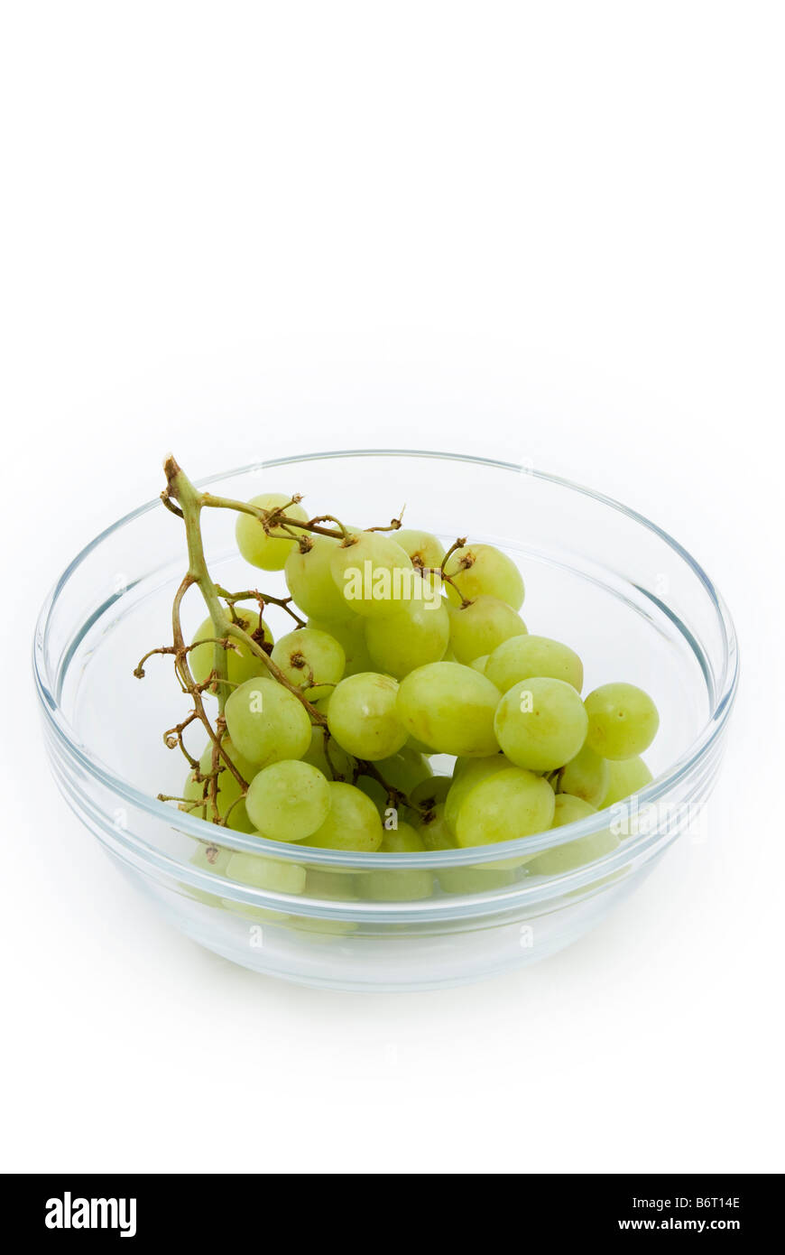 glass bowl containing a bunch of grapes Stock Photo