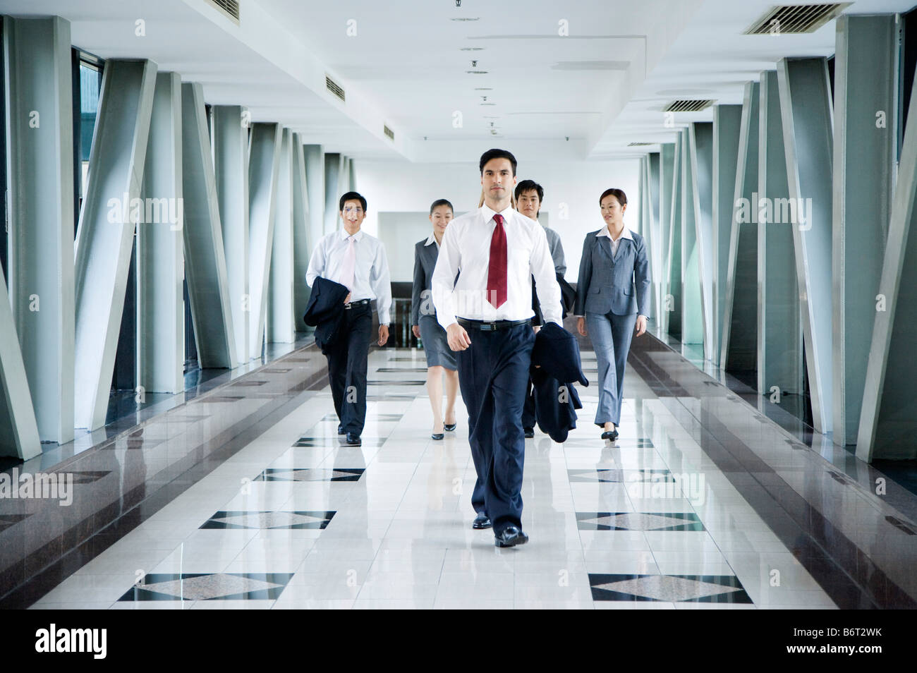 Business people walking in the office building Stock Photo - Alamy