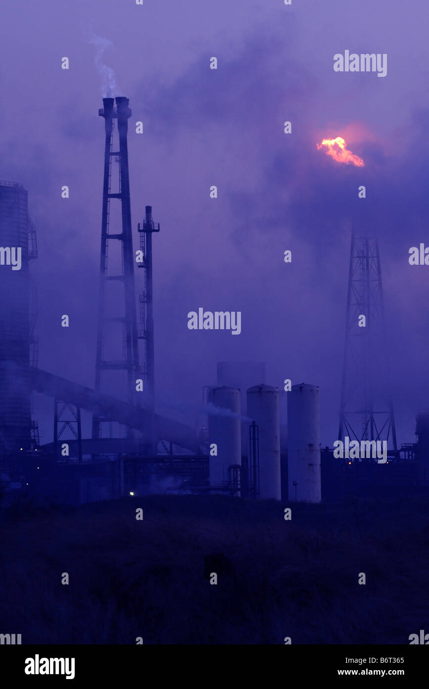 Steel factory chimneys and gas flare stack at Redcar Cleveland Teesside at dusk Stock Photo